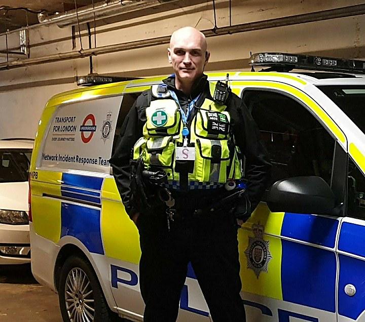 David in his police days, in medical response kit beside a Transport for London incident response vehicle