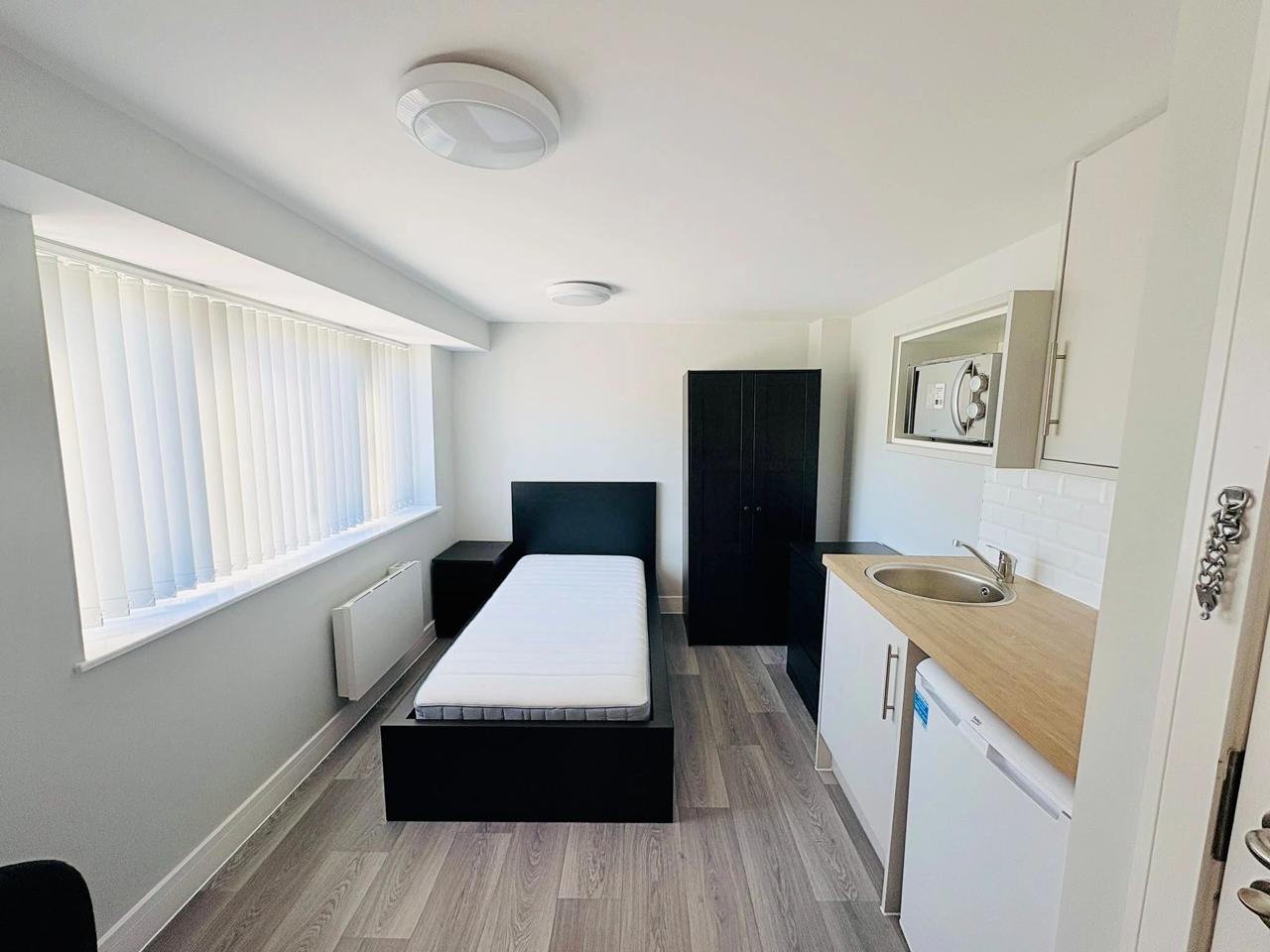 Inside one of the Veteran Housing Group units, bed and window