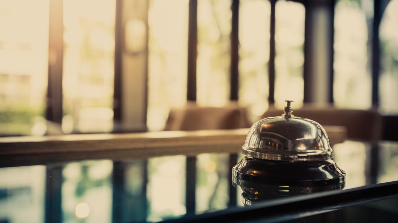 A concierge at a hotel reception desk